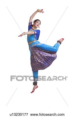 Full length of young woman performing Bharat Natyam dance over white background View Large Photo Image Stock Photo - Full length of young woman performing Bharat Natyam dance over white background. Fotosearch