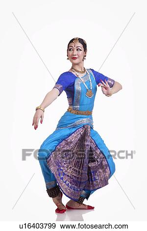 Full length of young woman performing Bharatanatyam over white background View Large Photo Image Stock Photo - Full length of young woman performing Bharatanatyam over white background. Fotosearch
