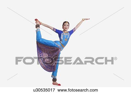 Full length of young woman performing Bharat Natyam dance over white background View Large Photo Image Stock Photo - Full length of young woman performing Bharat Natyam dance over white background. Fotosearch