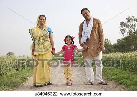Full length portrait of a young girl with her family walking on rural road View Large Photo Image Stock Image - Full length portrait of a young girl with her family walking on rural road . Fotosearch