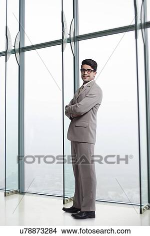Picture - Full length portrait of confident businessman in office. Fotosearch