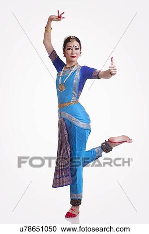 Full length portrait of confident young woman performing Bharatanatyam over white background View Large Photo Image Stock Image - Full length portrait of confident young woman performing Bharatanatyam over white background. Fotosearch