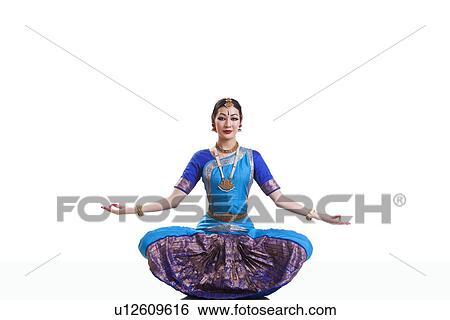 Stock Photograph - Full length portrait of dancer performing Bharatanatyam against white background. Fotosearch