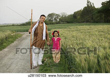 Full length portrait of father and daughter standing together in wheat field View Large Photo Image Stock Image - Full length portrait of father and daughter standing together in wheat field . Fotosearch