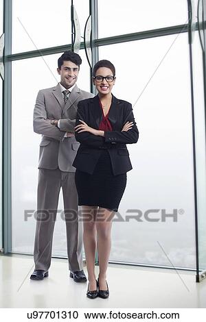 Full length portrait of happy business colleagues standing arms crossed in office View Large Photo Image Stock Image - Full length portrait of happy business colleagues standing arms crossed in office. Fotosearch