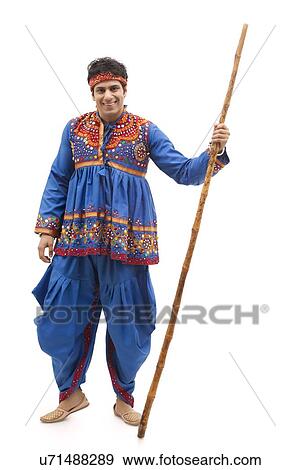 Full length portrait of happy young man in kedia and dhoti holding stick isolated over white background View Large Photo Image Stock Photo - Full length portrait of happy young man in kedia and dhoti holding stick isolated over white background. Fotosearch