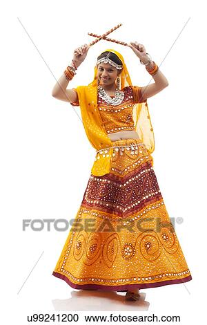 Full length portrait of happy young woman playing Dandiya Raas isolated over white background View Large Photo Image Stock Image - Full length portrait of happy young woman playing Dandiya Raas isolated over white background. Fotosearch