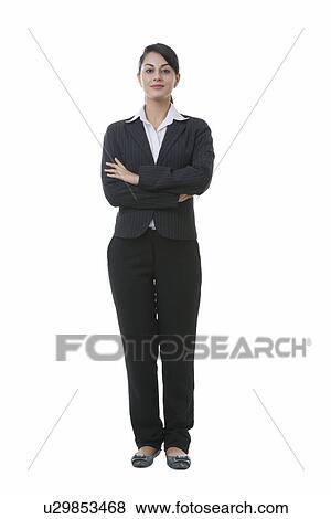 Full length portrait of well-dressed Indian businesswoman standing against white background View Large Photo Image Stock Photo - Full length portrait of well-dressed Indian businesswoman standing against white background. Fotosearch