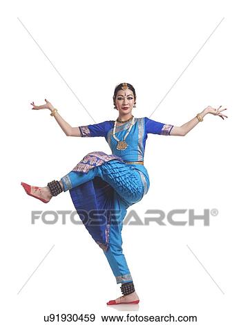 Stock Photo - Full length portrait of young woman performing Bharatanatyam over white background. Fotosearch