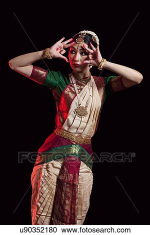 Furious Bharatanatyam dancer performing over black background View Large Photo Image Stock Image - Furious Bharatanatyam dancer performing over black background. Fotosearch