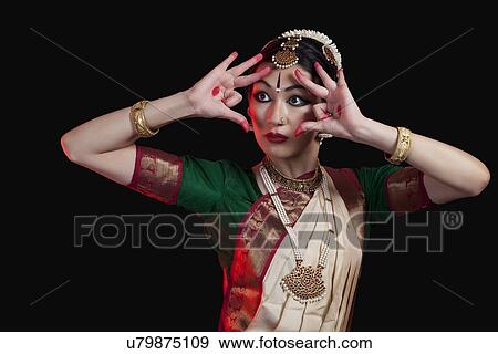 Furious Bharatanatyam dancer performing against black background View Large Photo Image Stock Photo - Furious Bharatanatyam dancer performing against black background. Fotosearch