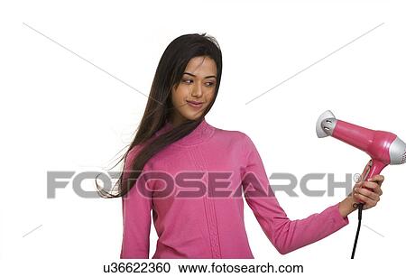 Girl blow drying her hair View Large Photo Image Stock Image - Girl blow drying her hair . Fotosearch