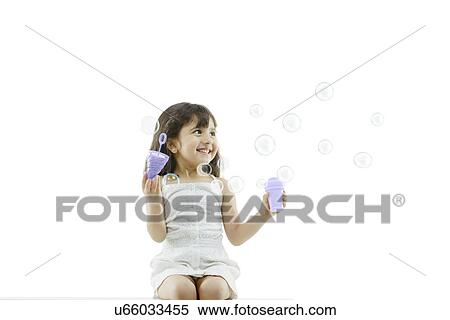 Stock Photography - Girl blowing bubbles . Fotosearch