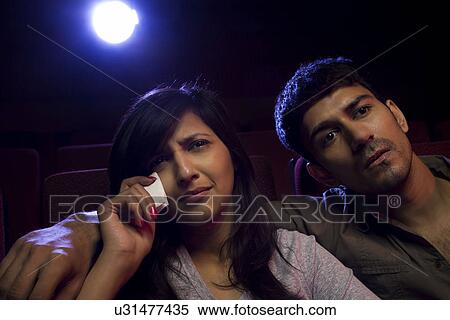 Girl getting emotional during a movie View Large Photo Image Stock Photography - Girl getting emotional during a movie . Fotosearch