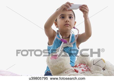 Stock Photography - Girl holding a toy thermometer . Fotosearch