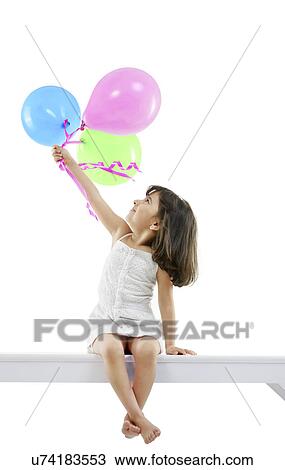 Girl holding balloons View Large Photo Image Stock Image - Girl holding balloons . Fotosearch