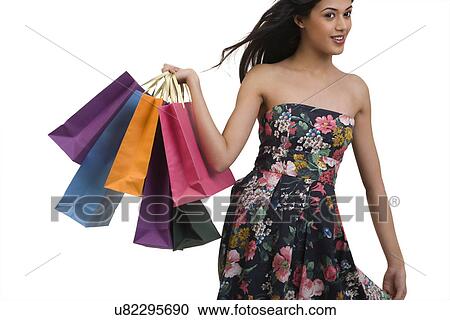 Stock Image - Girl holding shopping bags . Fotosearch