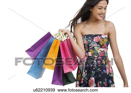 Stock Photo - Girl holding shopping bags . Fotosearch