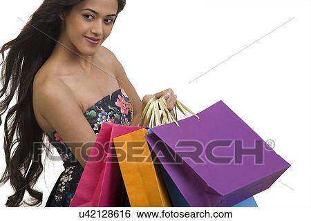 Girl holding shopping bags View Large Photo Image Stock Photograph - Girl holding shopping bags . Fotosearch