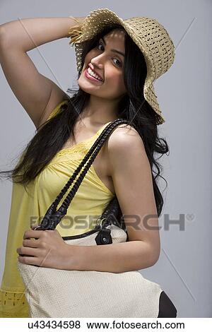 Stock Photo - Girl in a hat and bag . Fotosearch