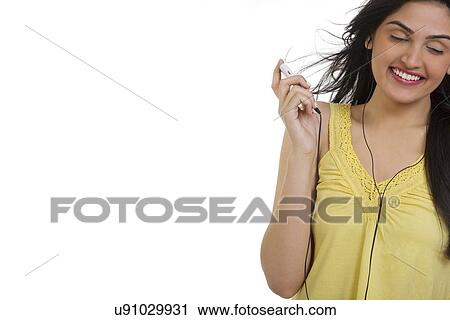 Girl listening to music on her mobile phone View Large Photo Image Stock Image - Girl listening to music on her mobile phone . Fotosearch