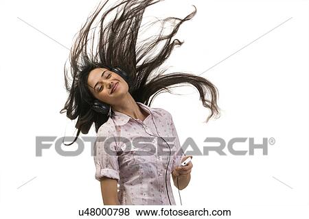 Girl listening to music on her mobile phone View Large Photo Image Stock Photo - Girl listening to music on her mobile phone . Fotosearch