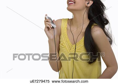 Girl listening to music on her mobile phone View Large Photo Image Stock Photography - Girl listening to music on her mobile phone . Fotosearch