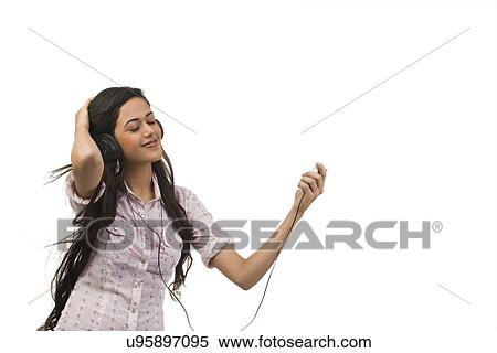 Girl listening to music on her mobile phone View Large Photo Image Stock Photography - Girl listening to music on her mobile phone . Fotosearch