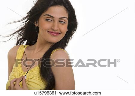 Stock Image - Girl listening to music . Fotosearch