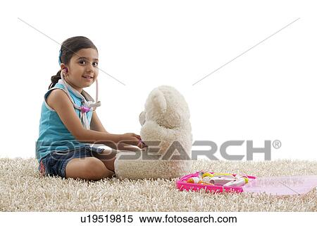 Girl playing doctor with her teddy bear View Large Photo Image Stock Photography - Girl playing doctor with her teddy bear . Fotosearch