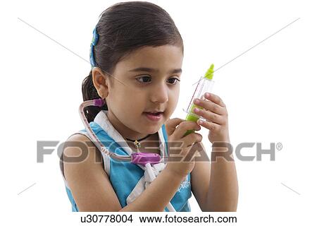Picture - Girl playing doctor with her toys . Fotosearch