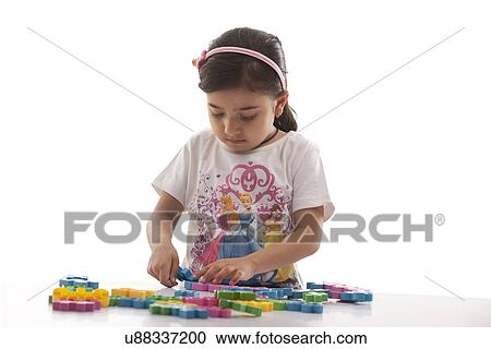 Girl playing with building blocks View Large Photo Image Stock Image - Girl playing with building blocks . Fotosearch