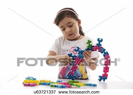 Girl playing with building blocks View Large Photo Image Stock Photo - Girl playing with building blocks . Fotosearch