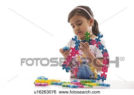 Stock Photograph - Girl playing with building blocks . Fotosearch