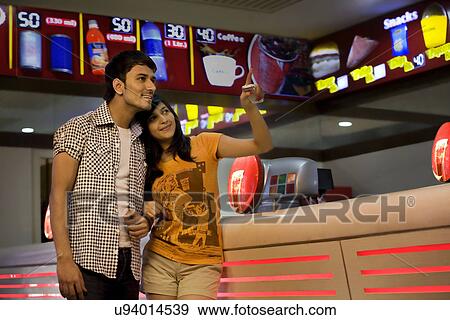 Girl pointing something out to her boyfriend View Large Photo Image Stock Photo - Girl pointing something out to her boyfriend . Fotosearch