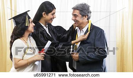 Girl putting her medal around her fathers neck View Large Photo Image Stock Image - Girl putting her medal around her fathers neck . Fotosearch