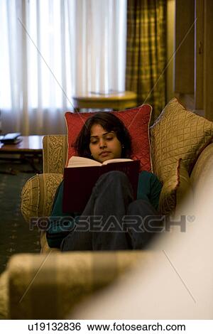 Stock Photograph - Girl reading a book . Fotosearch