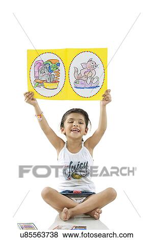 Girl showing her drawings View Large Photo Image Stock Photo - Girl showing her drawings . Fotosearch