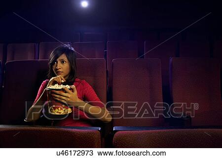Girl watching a movie View Large Photo Image Stock Image - Girl watching a movie . Fotosearch