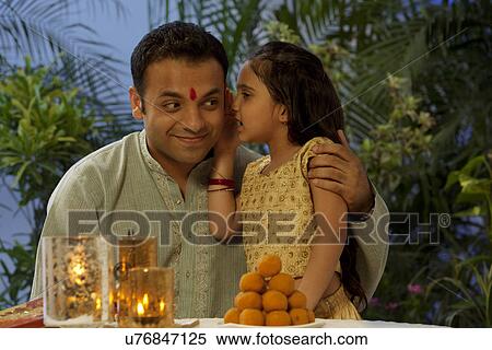 Girl whispering in her fathers ear View Large Photo Image Stock Photography - Girl whispering in her fathers ear . Fotosearch