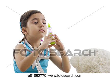 Stock Image - Girl with a toy injection playing doctor . Fotosearch