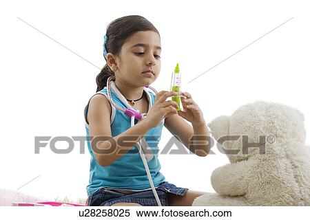 Girl with a toy injection playing doctor View Large Photo Image Stock Photography - Girl with a toy injection playing doctor . Fotosearch