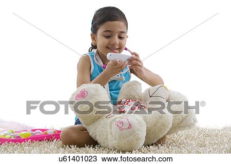 Girl with a toy thermometer View Large Photo Image Stock Image - Girl with a toy thermometer . Fotosearch