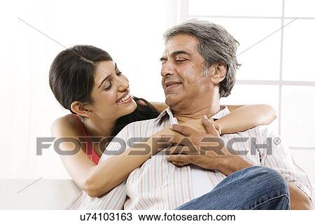 Girl with her arms around her father View Large Photo Image Stock Image - Girl with her arms around her father . Fotosearch