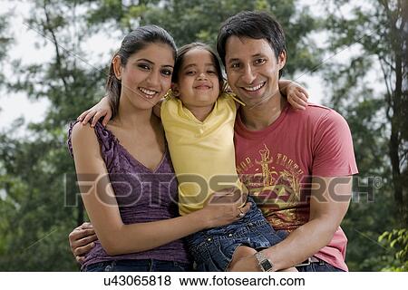 Stock Photo - Girl with her parents . Fotosearch