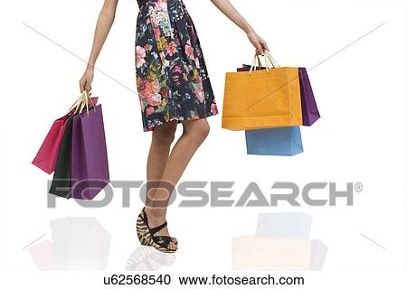 Stock Image - Girl with shopping bags . Fotosearch