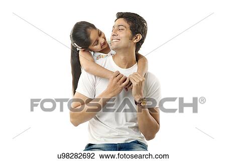 Girl wrapping her arms around her fathers neck View Large Photo Image Stock Image - Girl wrapping her arms around her fathers neck . Fotosearch