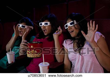 Girls enjoying themselves in a cinema hall View Large Photo Image Stock Image - Girls enjoying themselves in a cinema hall . Fotosearch