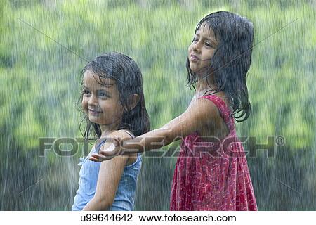 Stock Image - Girls standing in the rain . Fotosearch