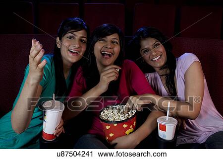 Stock Image - Girls watching a movie . Fotosearch